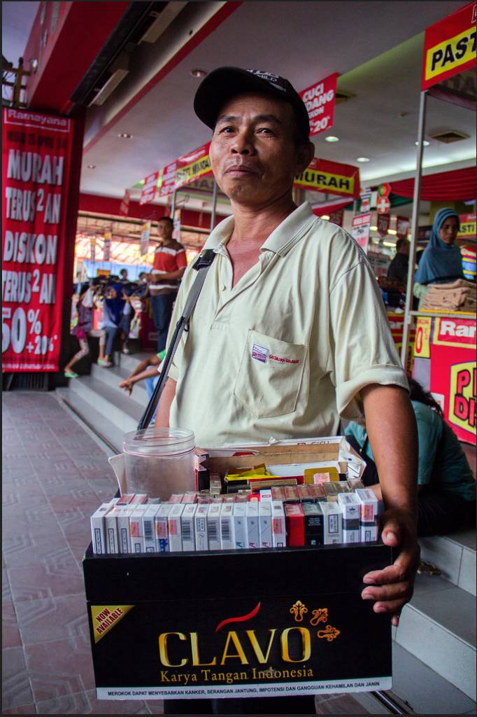 A person standing in front of a store

Description automatically generated